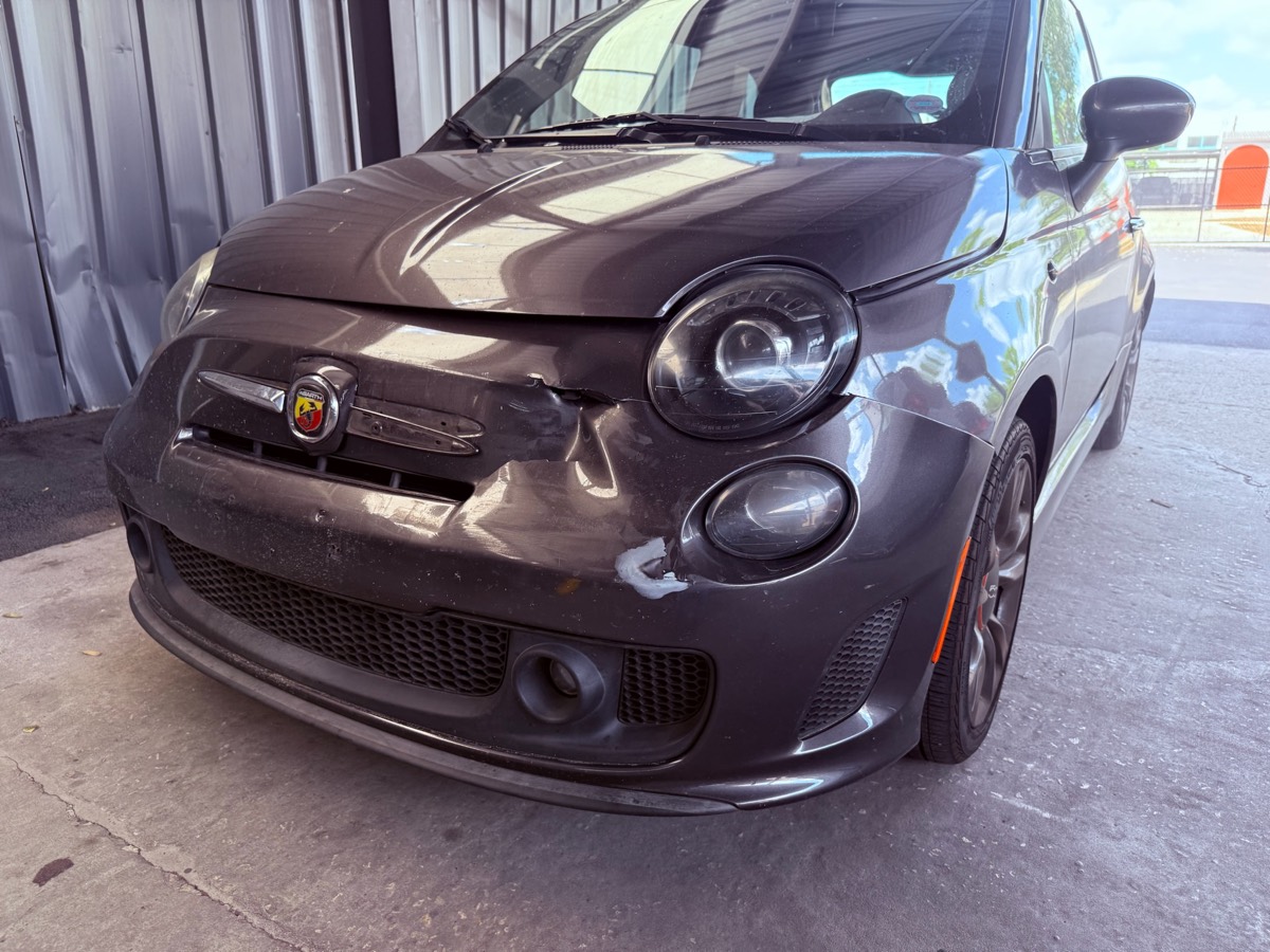 Front-end panel damage at intake before repair at Collision Center Orlando