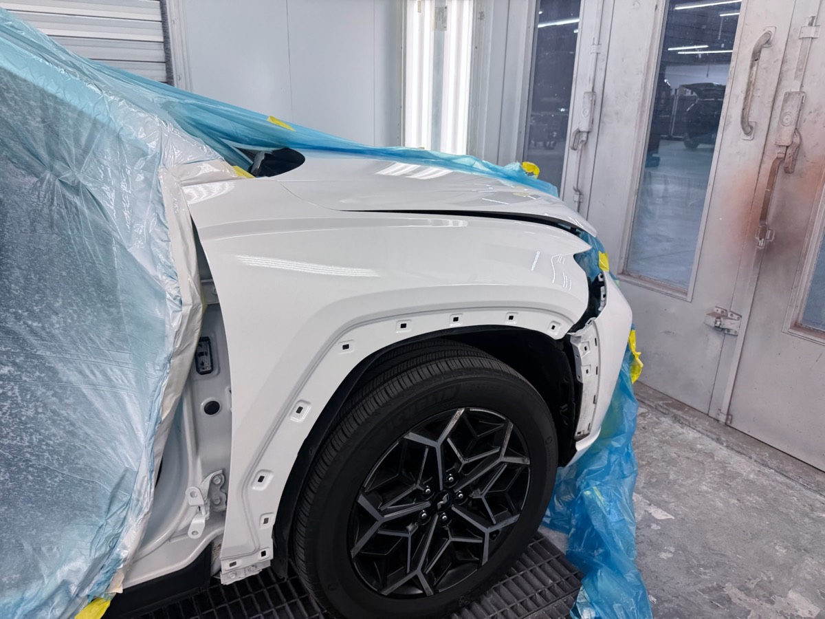 Precision masking before OEM-matched refinishing in the Collision Center Orlando paint booth