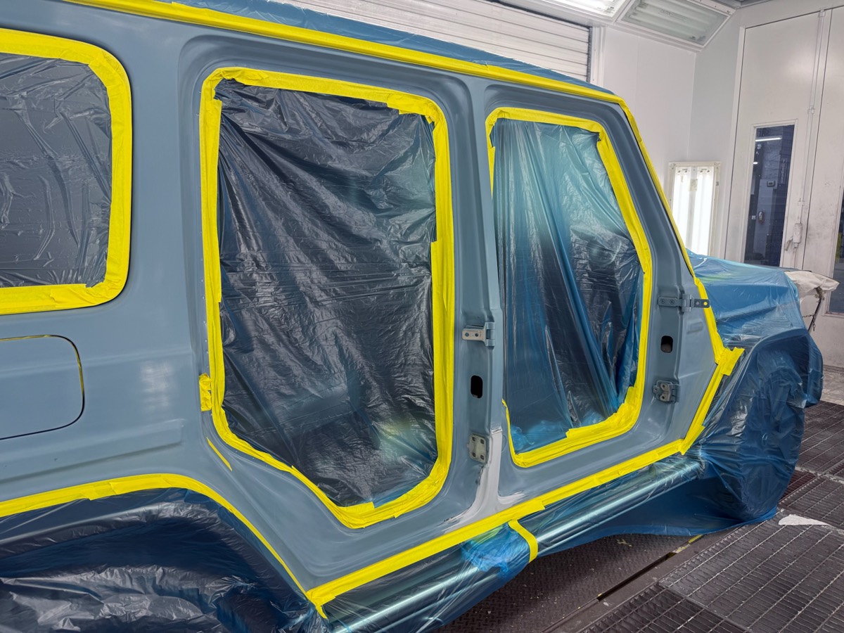 A vehicle masked and prepped in the Collision Center Orlando refinish paint booth