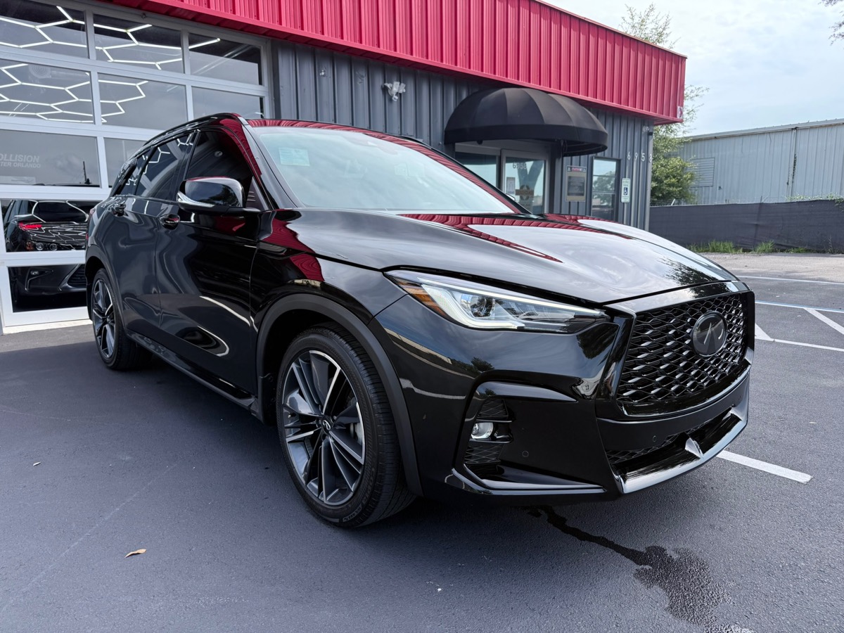 Black Infiniti SUV outside Collision Center Orlando after completed collision repair
