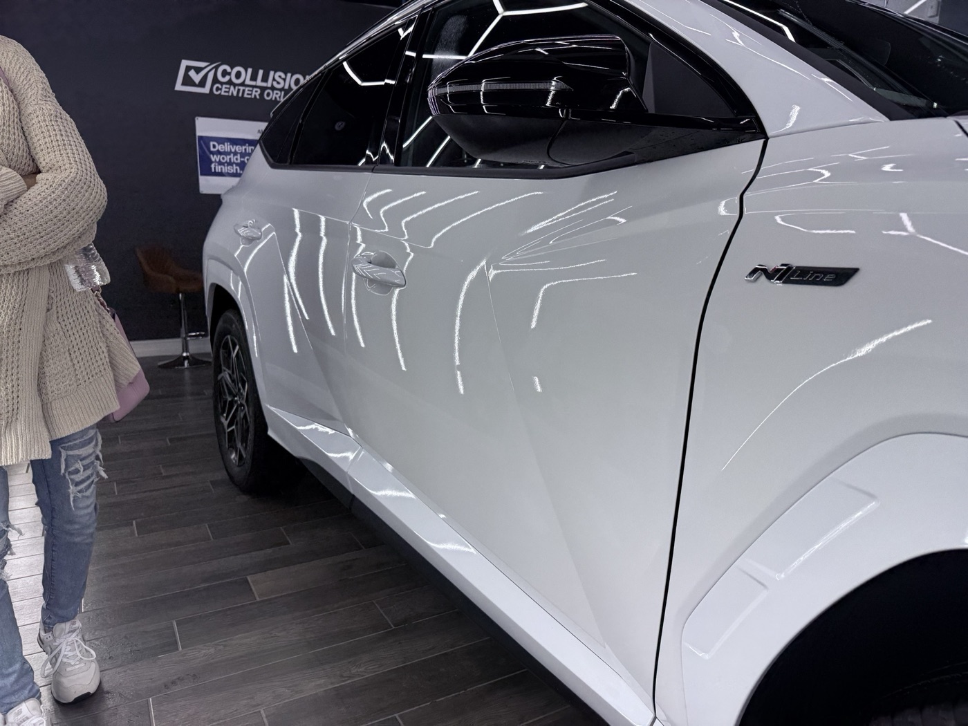 A finished white Hyundai delivered in the Collision Center Orlando showroom