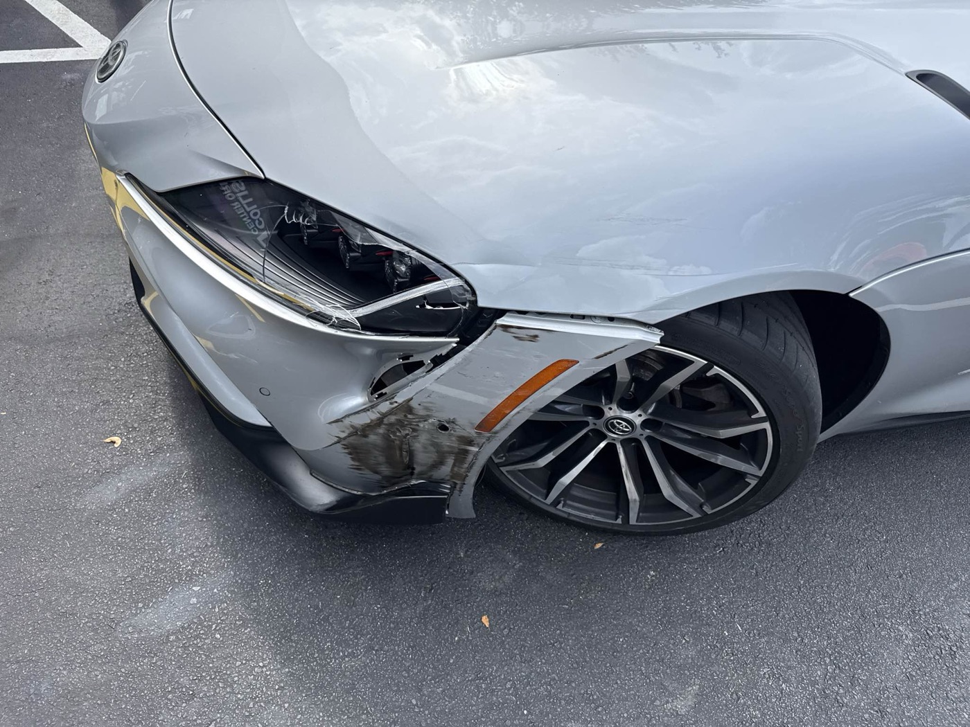 Front-end collision damage on a Toyota Supra at intake at Collision Center Orlando in Orlando