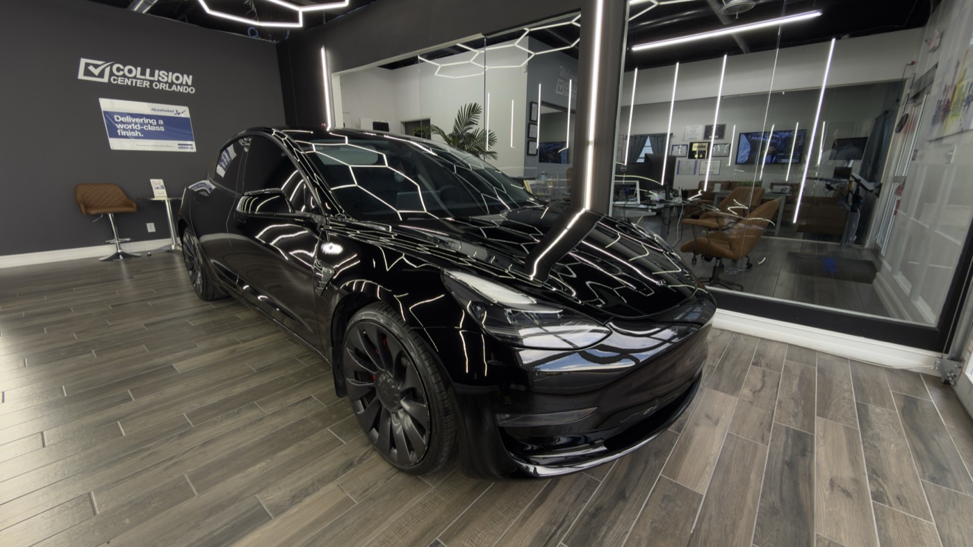 Black Tesla restored to a factory finish in the Collision Center Orlando delivery showroom