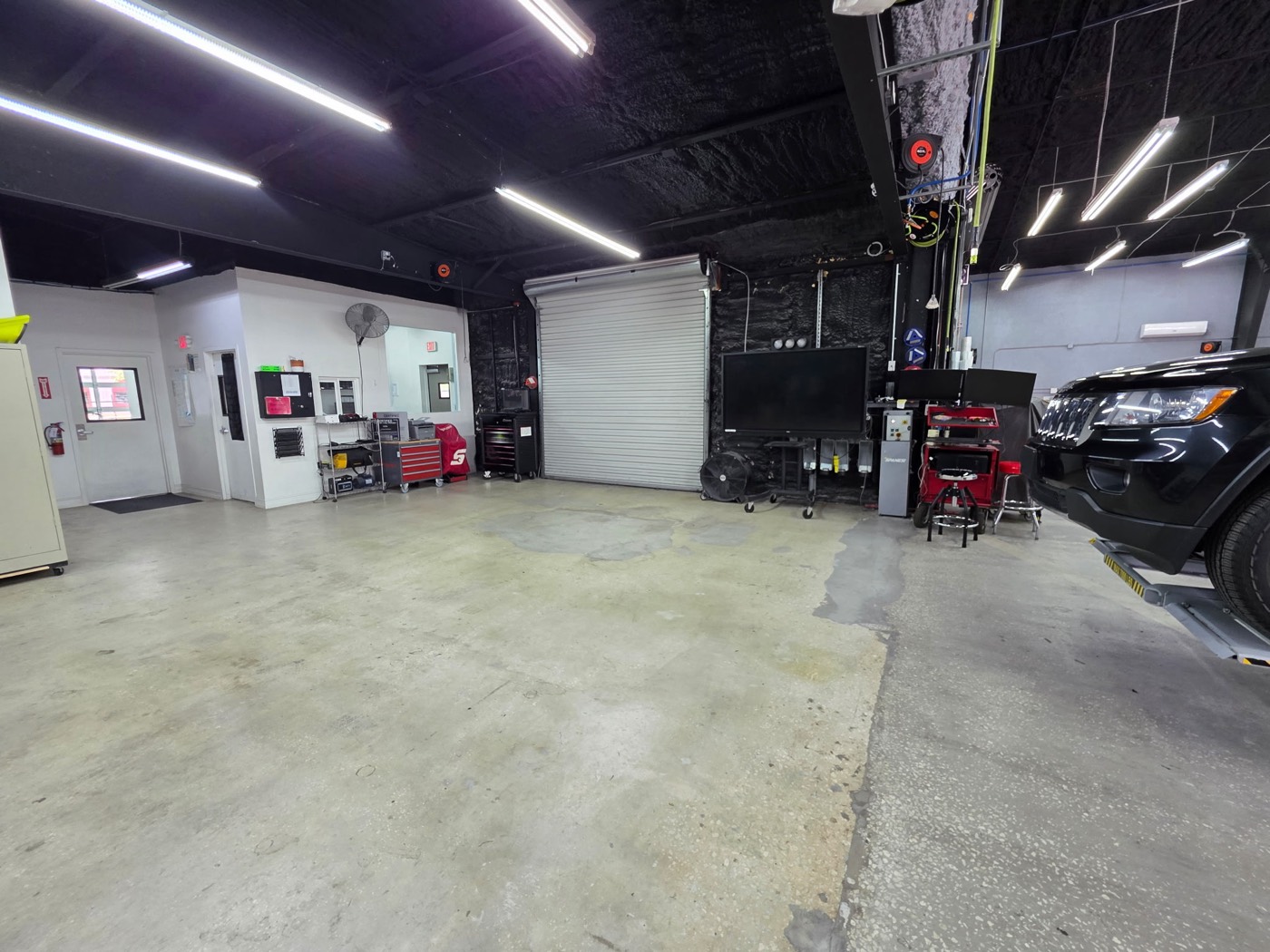 Inside the Collision Center Orlando production floor — a clean, organized collision repair facility in Orlando